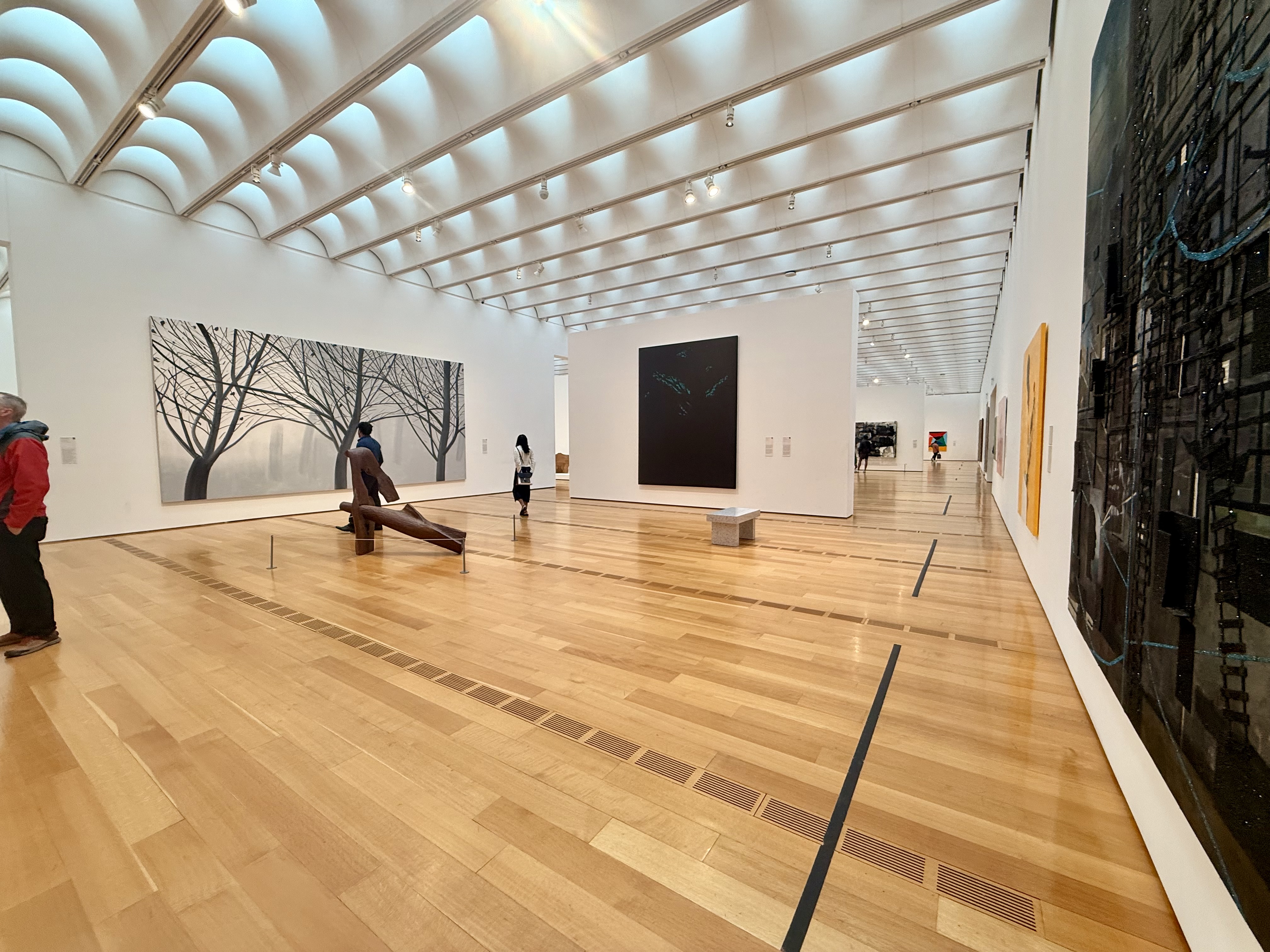 a photo of a gallery room with one giant painting per wall